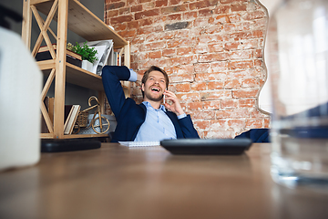 Image showing Young man, manager, team led return to work in his office after quarantine, feels happy and inspired