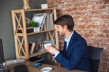 Image showing Young man, manager, team led return to work in his office after quarantine, feels happy and inspired