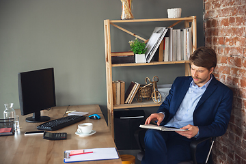 Image showing Young man, manager, team led return to work in his office after quarantine, feels happy and inspired