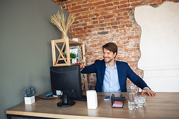 Image showing Young man, manager, team led return to work in his office after quarantine, feels happy and inspired