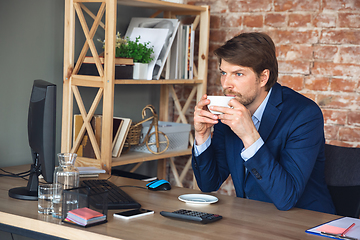 Image showing Young man, manager, team led return to work in his office after quarantine, feels happy and inspired