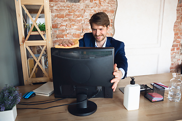 Image showing Young man, manager, team led return to work in his office after quarantine, feels happy and inspired