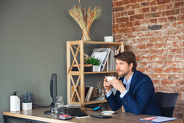 Image showing Young man, manager, team led return to work in his office after quarantine, feels happy and inspired