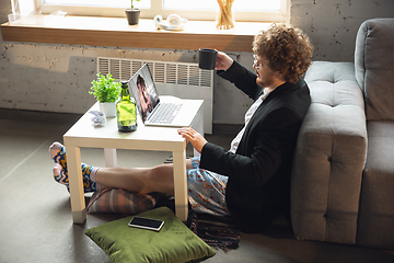 Image showing Young man without pants but in jacket working on a computer, laptop. Remote office during coronavirus, fun and comfortable work in underpants