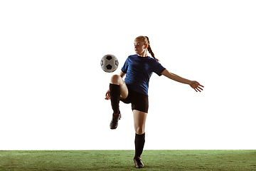 Image showing Female soccer, football player kicking ball, training in action and motion with bright emotions isolated on white background