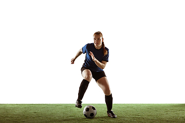 Image showing Female soccer, football player kicking ball, training in action and motion with bright emotions isolated on white background