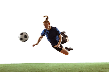 Image showing Female soccer, football player kicking ball, training in action and motion with bright emotions isolated on white background