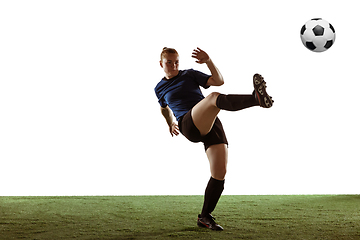 Image showing Female soccer, football player kicking ball, training in action and motion with bright emotions isolated on white background