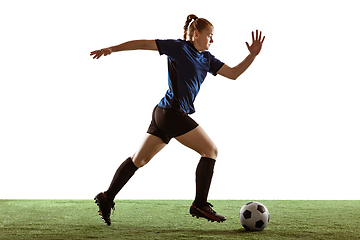 Image showing Female soccer, football player kicking ball, training in action and motion with bright emotions isolated on white background