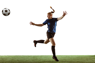 Image showing Female soccer, football player kicking ball, training in action and motion with bright emotions isolated on white background