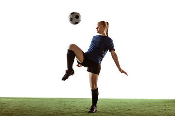 Image showing Female soccer, football player kicking ball, training in action and motion with bright emotions isolated on white background