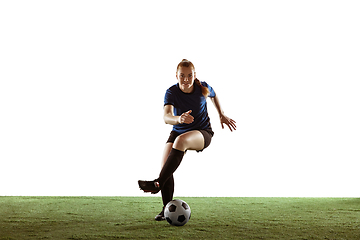 Image showing Female soccer, football player kicking ball, training in action and motion with bright emotions isolated on white background