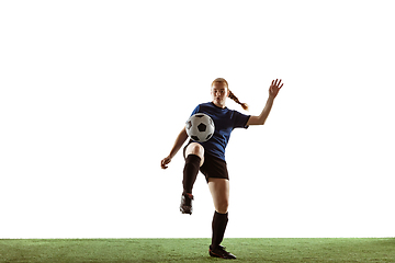 Image showing Female soccer, football player kicking ball, training in action and motion with bright emotions isolated on white background