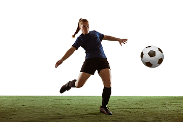 Image showing Female soccer, football player kicking ball, training in action and motion with bright emotions isolated on white background