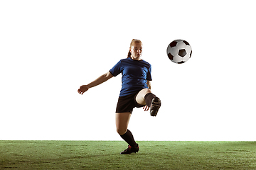 Image showing Female soccer, football player kicking ball, training in action and motion with bright emotions isolated on white background