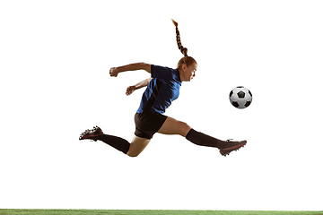 Image showing Female soccer, football player kicking ball, training in action and motion with bright emotions isolated on white background