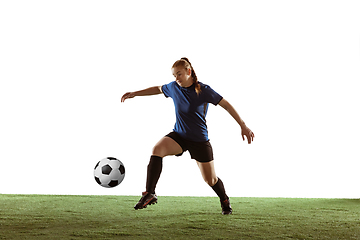 Image showing Female soccer, football player kicking ball, training in action and motion with bright emotions isolated on white background