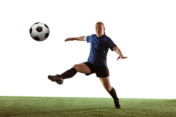 Image showing Female soccer, football player kicking ball, training in action and motion with bright emotions isolated on white background