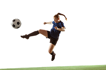 Image showing Female soccer, football player kicking ball, training in action and motion with bright emotions isolated on white background