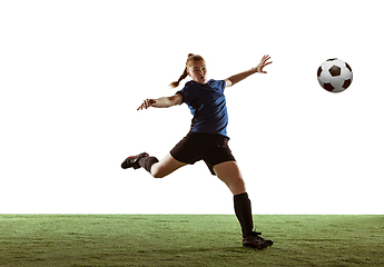 Image showing Female soccer, football player kicking ball, training in action and motion with bright emotions isolated on white background