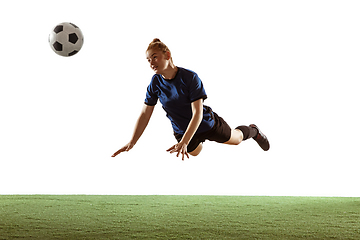 Image showing Female soccer, football player kicking ball, training in action and motion with bright emotions isolated on white background