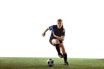 Image showing Female soccer, football player kicking ball, training in action and motion with bright emotions isolated on white background