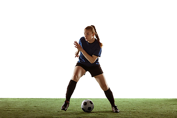 Image showing Female soccer, football player kicking ball, training in action and motion with bright emotions isolated on white background