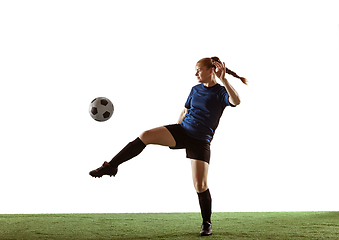 Image showing Female soccer, football player kicking ball, training in action and motion with bright emotions isolated on white background