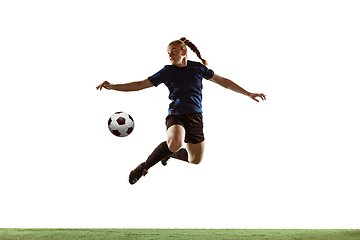 Image showing Female soccer, football player kicking ball, training in action and motion with bright emotions isolated on white background