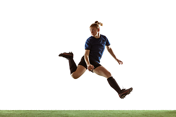 Image showing Female soccer, football player kicking ball, training in action and motion with bright emotions isolated on white background