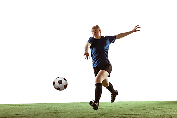 Image showing Female soccer, football player kicking ball, training in action and motion with bright emotions isolated on white background