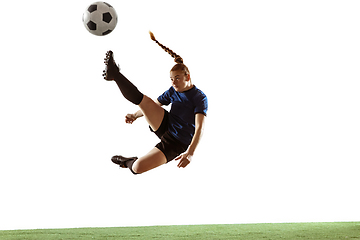 Image showing Female soccer, football player kicking ball, training in action and motion with bright emotions isolated on white background