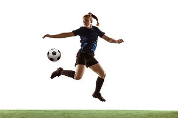 Image showing Female soccer, football player kicking ball, training in action and motion with bright emotions isolated on white background