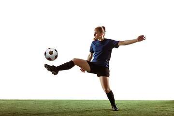 Image showing Female soccer, football player kicking ball, training in action and motion with bright emotions isolated on white background
