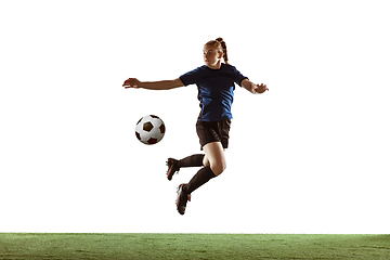 Image showing Female soccer, football player kicking ball, training in action and motion with bright emotions isolated on white background