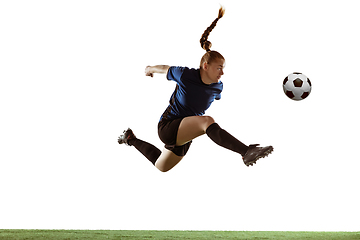 Image showing Female soccer, football player kicking ball, training in action and motion with bright emotions isolated on white background