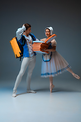 Image showing Young and graceful ballet dancers as Cinderella fairytail characters hurrying up with pizza like deliveryman