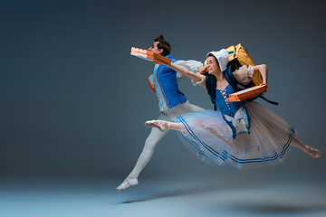 Image showing Young and graceful ballet dancers as Cinderella fairytail characters hurrying up with pizza like deliveryman