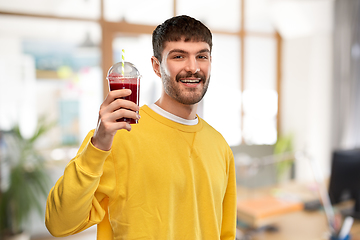 Image showing happy man with juice in plastic cup at office