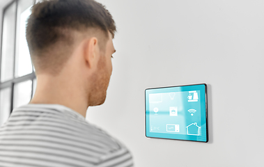 Image showing man looking at tablet computer at smart home