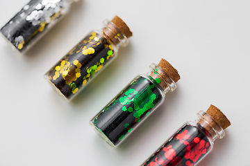 Image showing set of glitters in bottles over white background