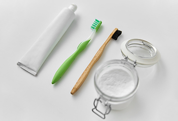 Image showing toothbrushes, toothpaste and soda in jar