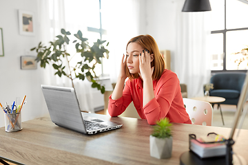 Image showing stressed woman with laptop working at home office