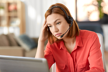 Image showing sad woman with headset and laptop working at home