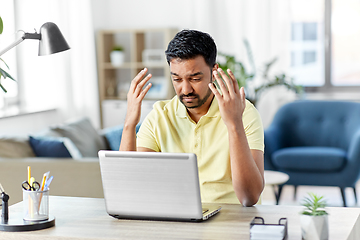 Image showing indian man with laptop working at home office