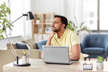 Image showing indian man with laptop thinking at home office