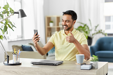 Image showing indian man having video call on smartphone at home