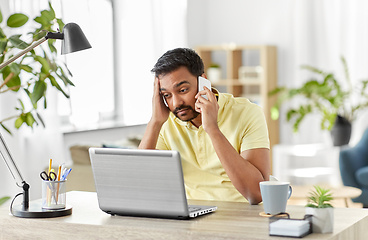 Image showing man calling on smartphone at home office