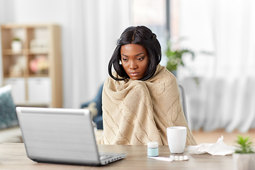 Image showing sick woman having video call on laptop at home