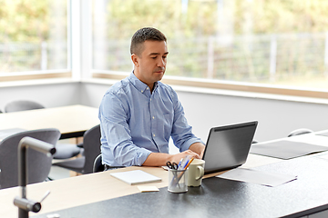 Image showing man with laptop working at home office